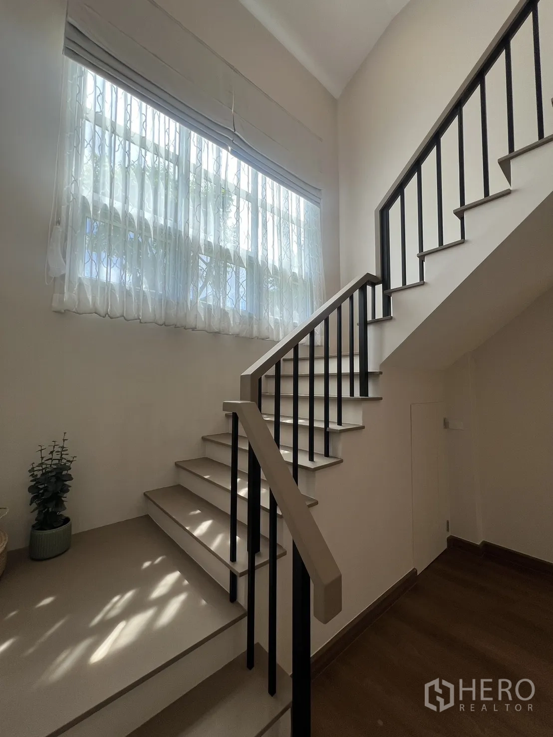 Detached House for rent in Mueang Samut Prakan, Samut Prakan - Spacious master bedroom with king bed, wood floors and sheer curtains.