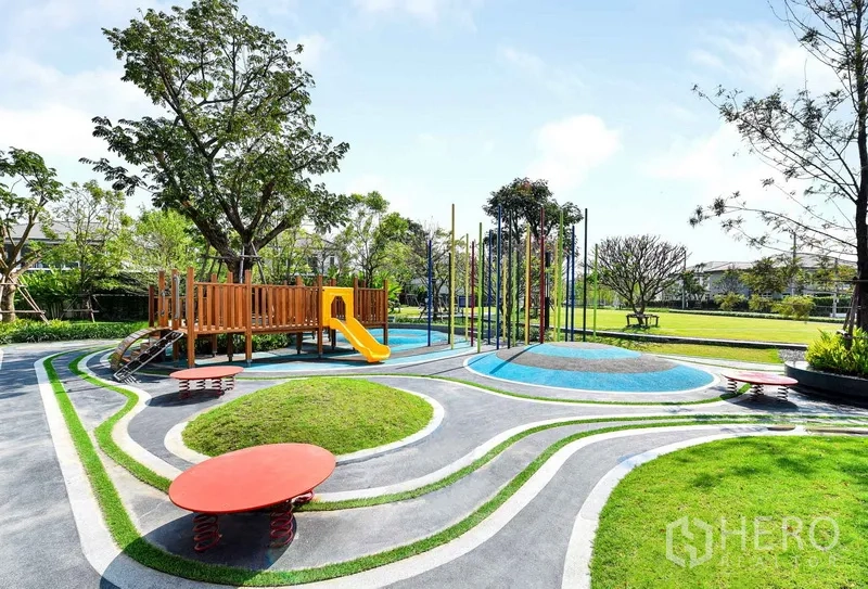 Detached House for rent in Samut Prakan - Children’s playground in the community park with slide and landscaped paths.