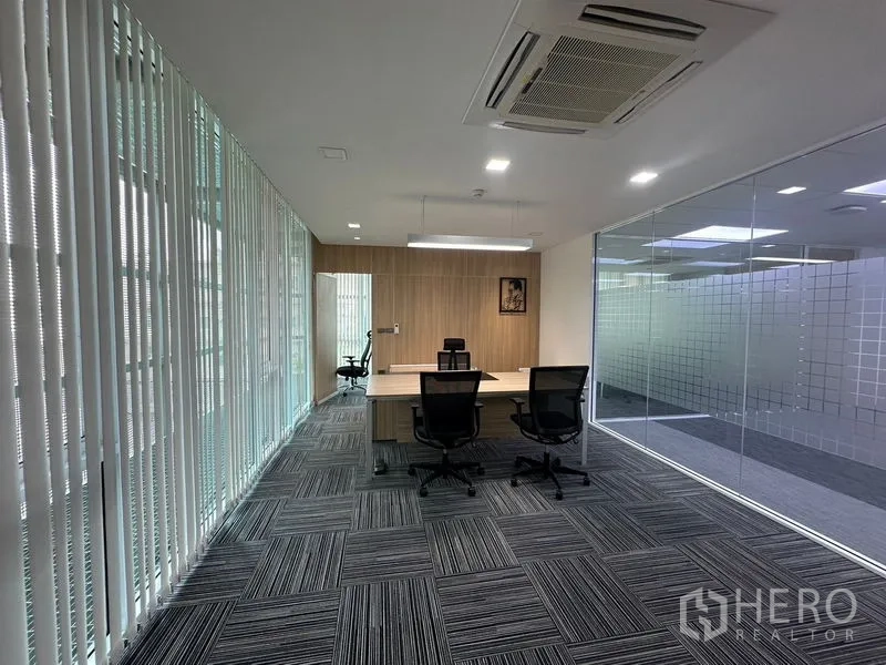 Office Space for rent - Compact meeting room with square table, eight chairs, cassette AC and full-height windows.