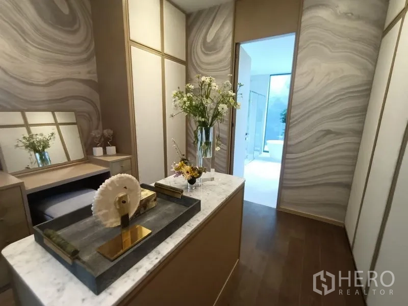 Detached House for sale - Walk‑in closet featuring marble‑top island, built‑in wardrobes and view to ensuite bathroom.