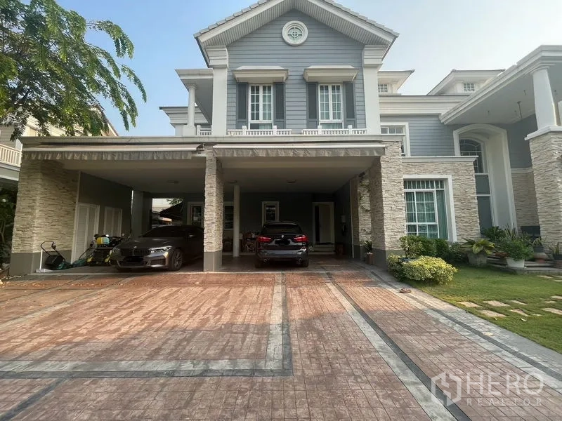 Detached House for rent in Bang Phli, Samut Prakan - Grey two-storey home with large driveway and covered carport.