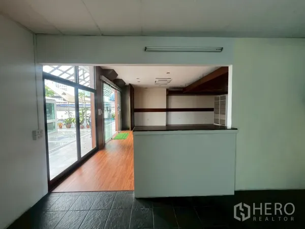 Retail Space for rent - View from back counter toward the glass frontage and covered walkway outside.