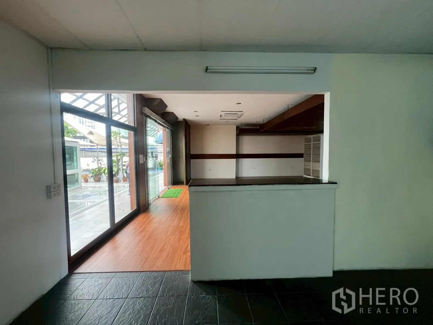 Retail Space for rent - View from back counter toward the glass frontage and covered walkway outside.