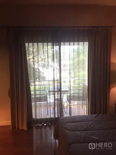 Detached House for sale in Lat Krabang, Bangkok - Sliding glass door with sheer curtains opening to a balcony seating area.