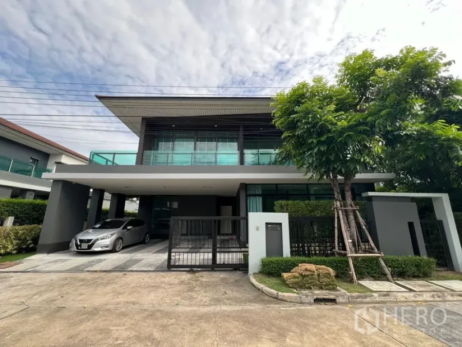 บ้าน ให้เช่าในBang Kapi, Bangkok - ด้านหน้าบ้านสมัยใหม่มีทางรถเข้าและโรงจอดรถพร้อมรั้ว