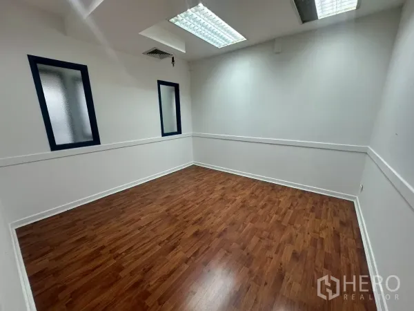 Office Space for rent in Khlong Toei, Bangkok - Bright meeting room with wood floors, frosted windows and fluorescent ceiling lights.