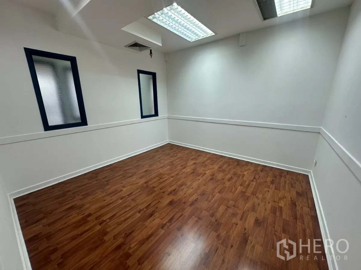 Office Space for rent in Khlong Toei, Bangkok - Bright meeting room with wood floors, frosted windows and fluorescent ceiling lights.