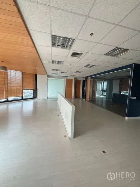 Office Space for rent in Bang Na, Bangkok - Open-plan office with ceiling tiles, wooden accents, glass partition and window blinds.