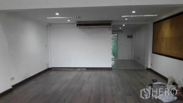 办公空间 出租在Bueng Kum, Bangkok - 一层办公室，深色木地板、筒灯与空调机。