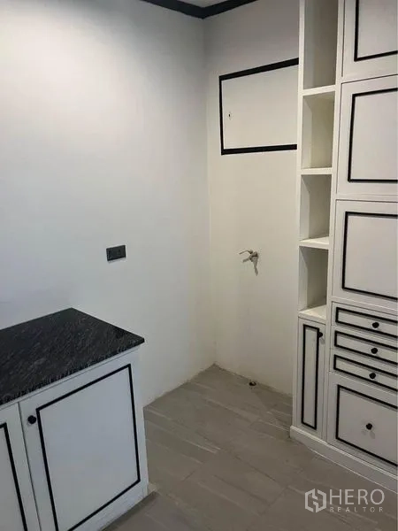 Condominium for rent or sale in Watthana, Bangkok - Utility corner with storage cabinetry and water hookup for laundry.