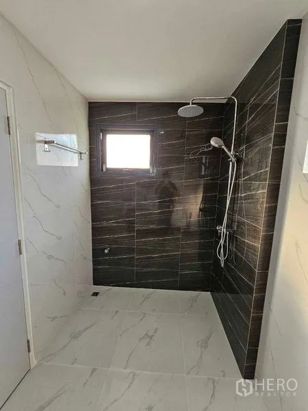 Detached House for sale in Thanyaburi, Pathum Thani - Walk-in shower with dark tiled wall and rainfall showerhead.