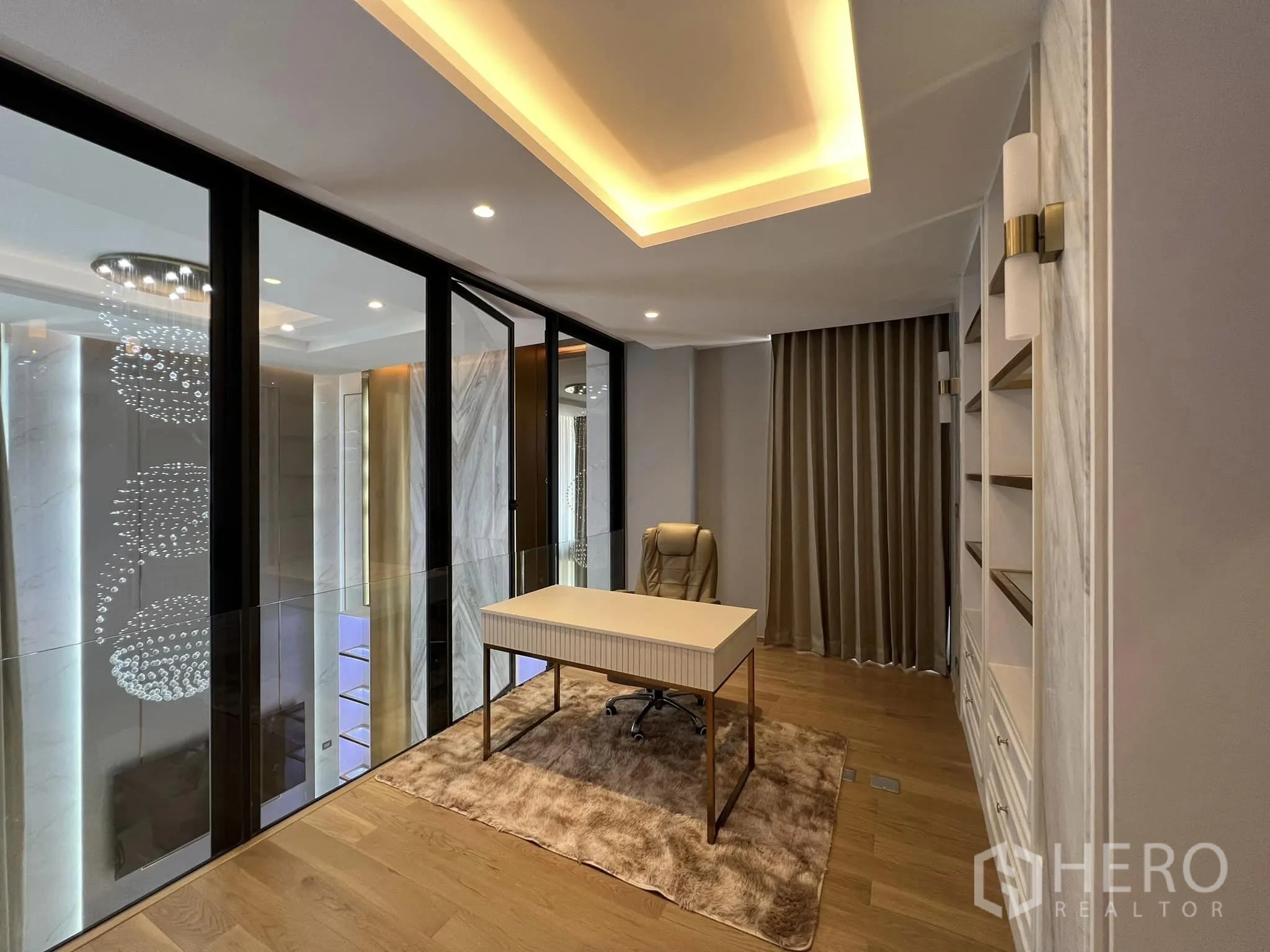 Detached House for rent or sale in Yan Nawa, Bangkok - Glass-walled mezzanine home office with desk and built-in shelves.