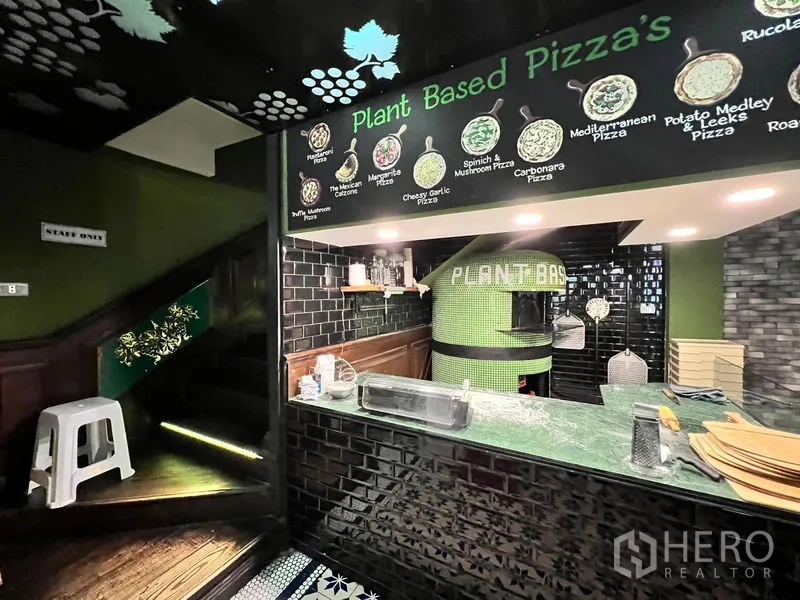 Shophouse for rent in Watthana, Bangkok - Pizza counter beside a staircase in a fitted F&B space with mosaic floor tiling.