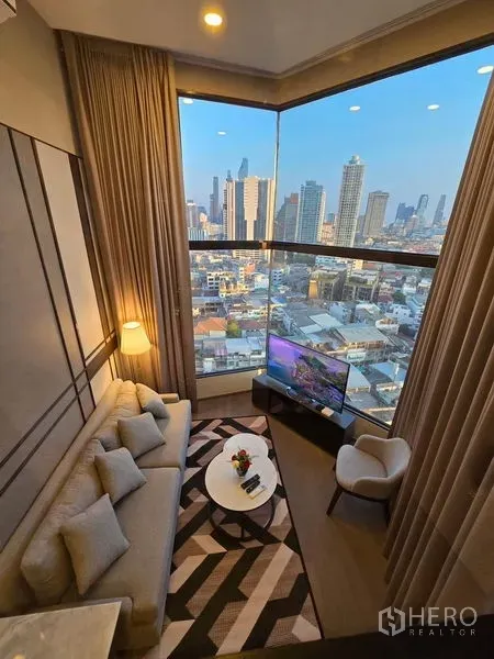 Condominium for rent - Aerial view of the living room showcasing the large corner window and skyline panorama.