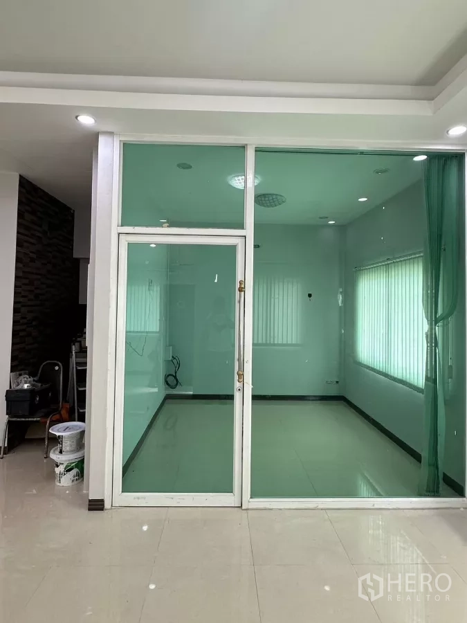 Home Office for rent in Bang Phli, Samut Prakan - Glass-walled meeting or manager’s room with sliding door and vertical blinds.