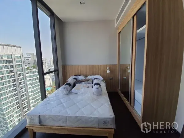 公寓 出租在Watthana, Bangkok - 采光充足的卧室，转角落地窗与内嵌衣柜