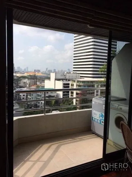 Condominium for rent or sale in Watthana, Bangkok - Balcony with washing machine and open city skyline view.