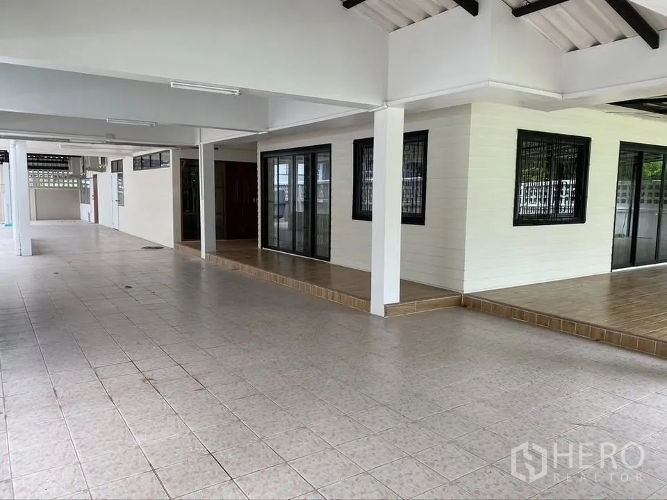 Detached House for rent in Suan Luang, Bangkok - Covered terrace surrounding the house with tiled floors and sliding doors.