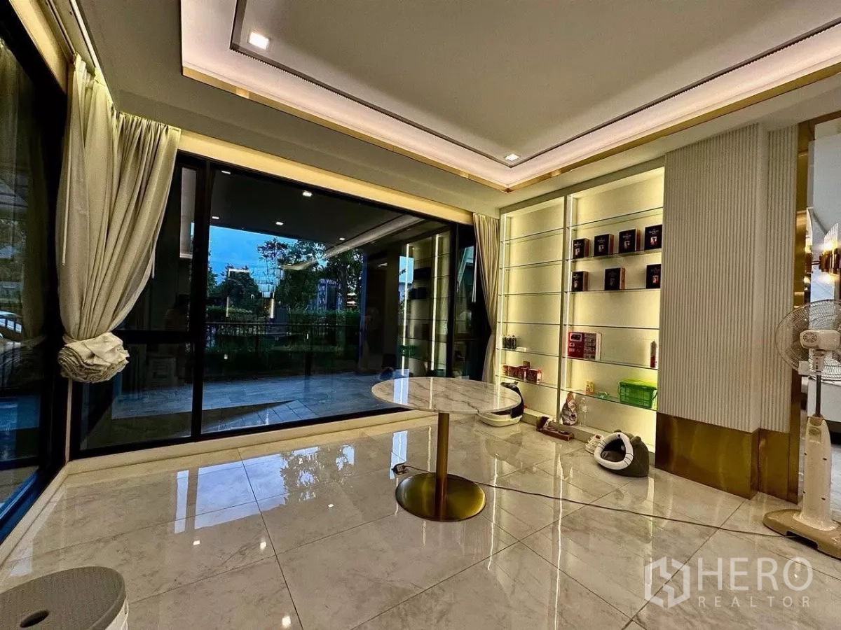 Detached House for sale in Saphan Sung, Bangkok - Multipurpose room with sliding glass doors and illuminated display shelving.