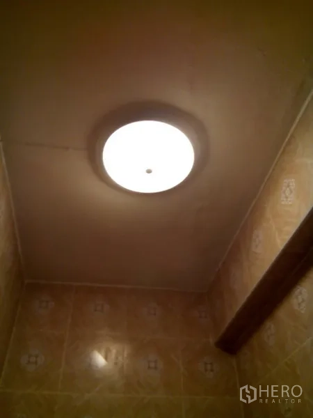 Shophouse for rent in Phra Khanong, Bangkok - Ceiling-mounted light fixture glowing in the bathroom.