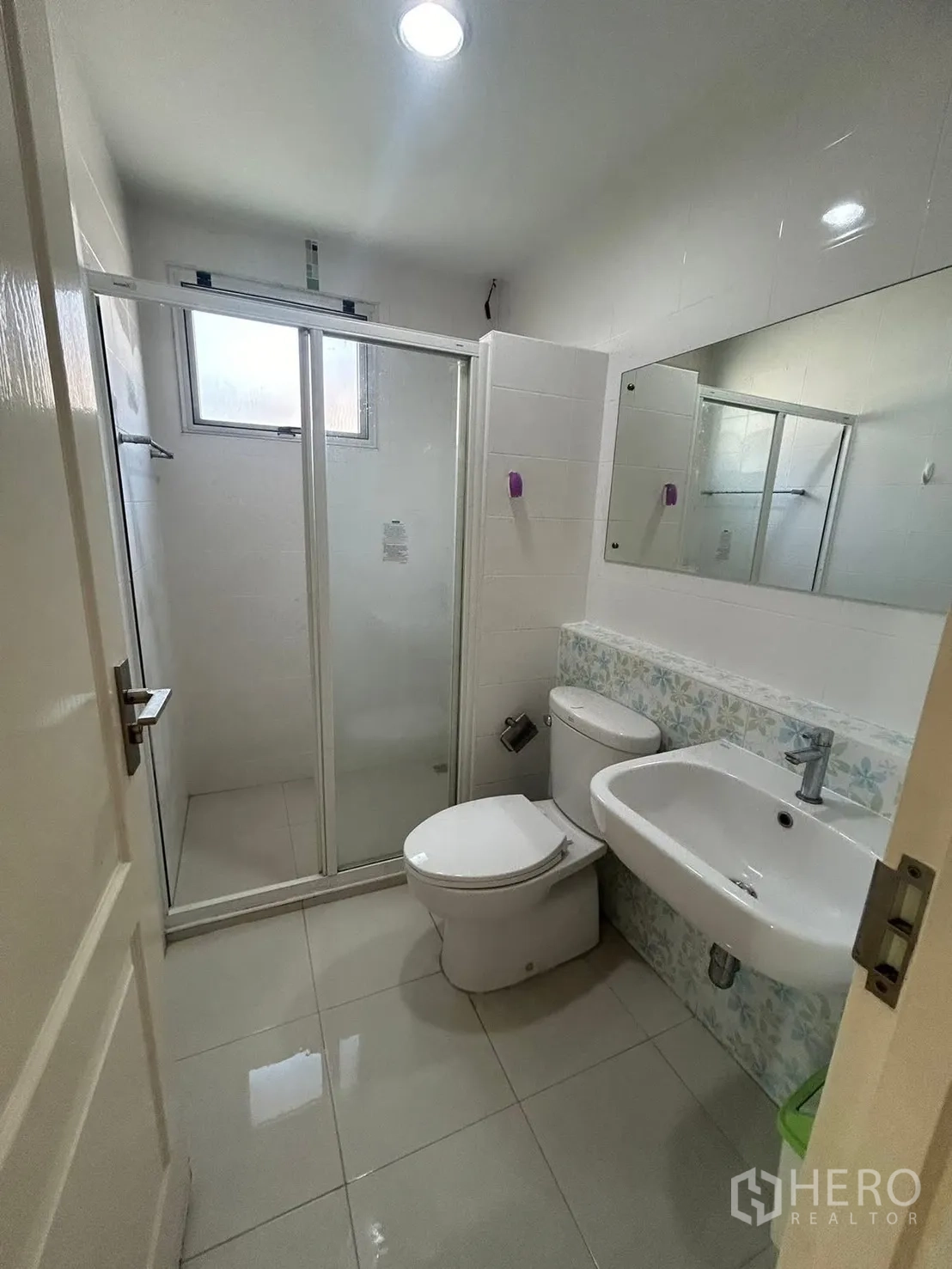Detached House for rent in Bang Na, Bangkok - Compact bathroom with enclosed shower, toilet, and wall mirror.