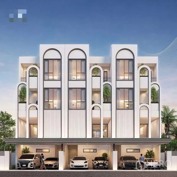 Townhouse for sale - Street-level view of a townhouse row with arched architecture and multiple covered carports.