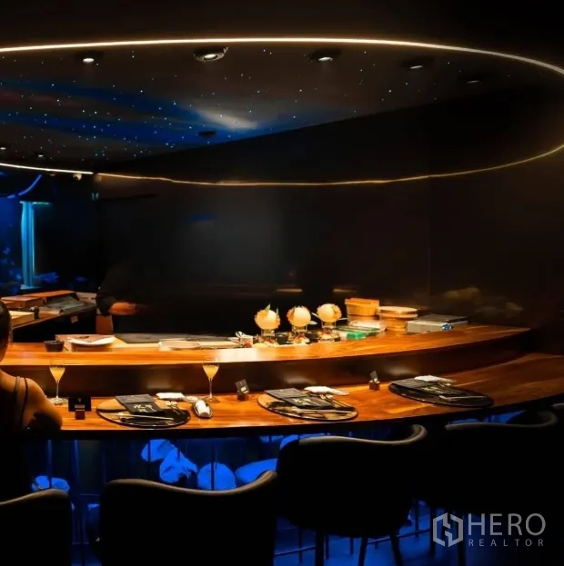 Retail Space for rent in Watthana, Bangkok - Close view of wooden chef’s counter with place settings beneath halo-lit ceiling.