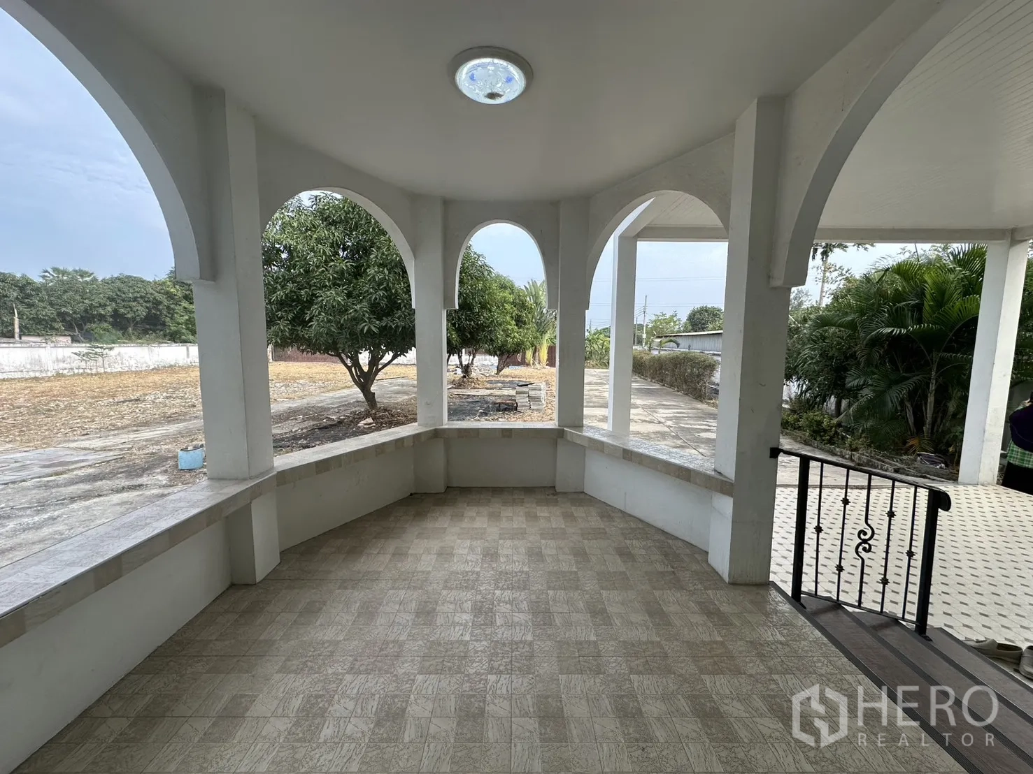 Home Office for rent - Covered front terrace with arched openings overlooking the yard.