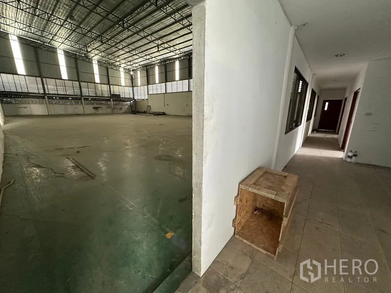 Warehouse for rent in Suan Luang, Bangkok - Transition from corridor to warehouse hall showing wide production space.
