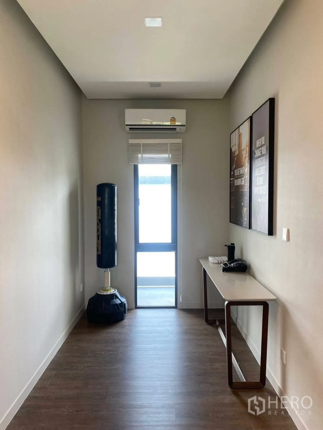 Detached House for rent or sale in Bang Phli, Samut Prakan - Long multipurpose room with window, air conditioner, and a punching bag.