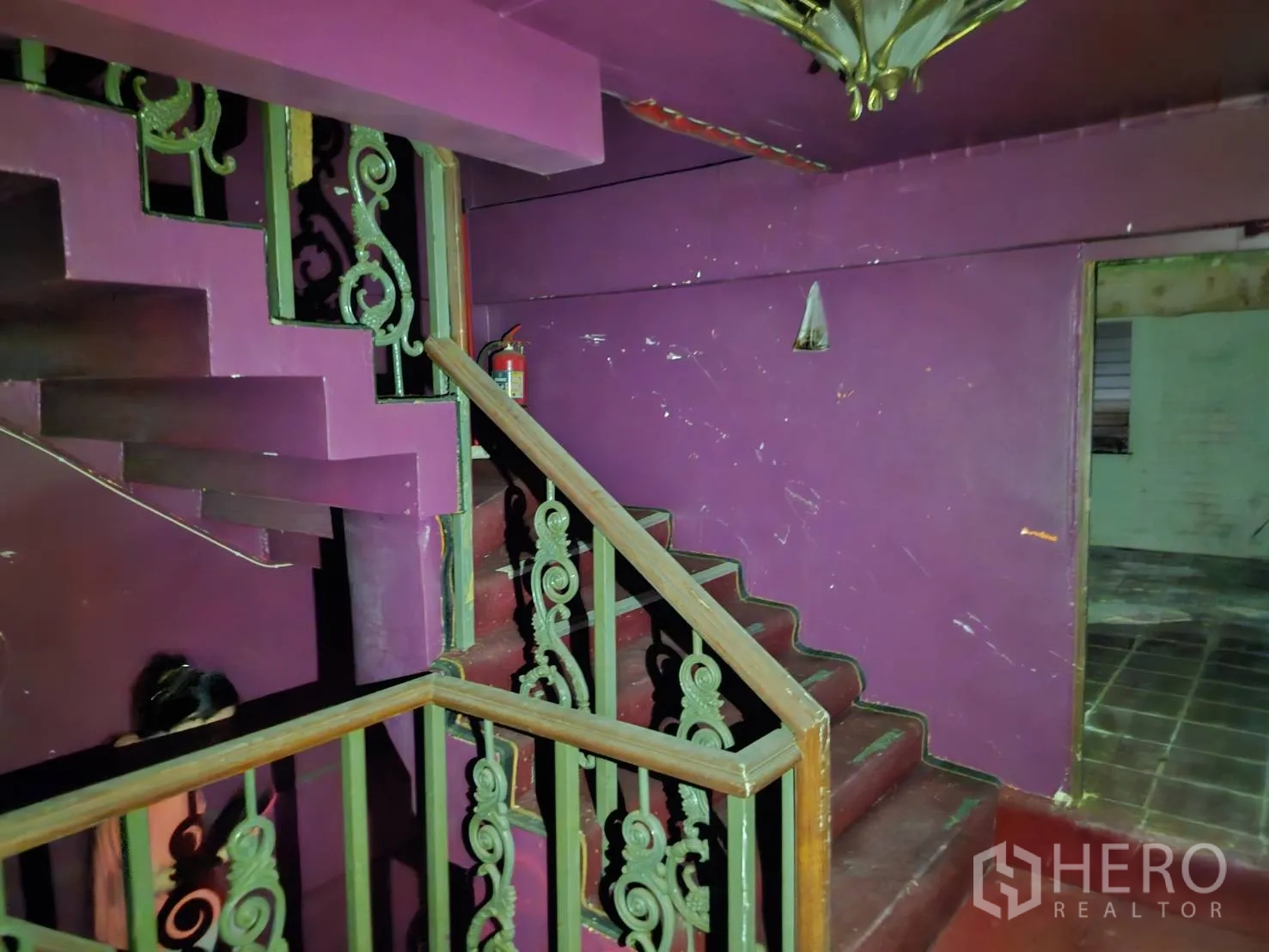 Shophouse for rent in Bang Rak, Bangkok - Upper landing with purple walls and decorative stairs leading to higher floors.