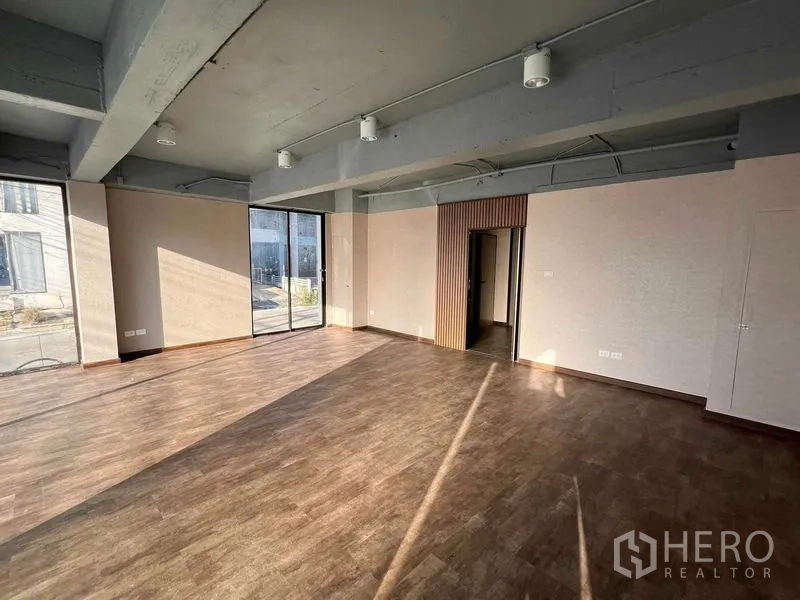 Office Space for rent or sale in Suan Luang, Bangkok - Open office area with floor-to-ceiling glazing and access to a small private room.