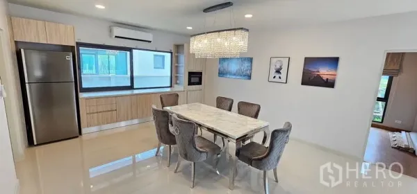 Detached House for rent - Modern dining-kitchen with a marble table for six, crystal chandelier, built-in cabinets and stainless refrigerator.
