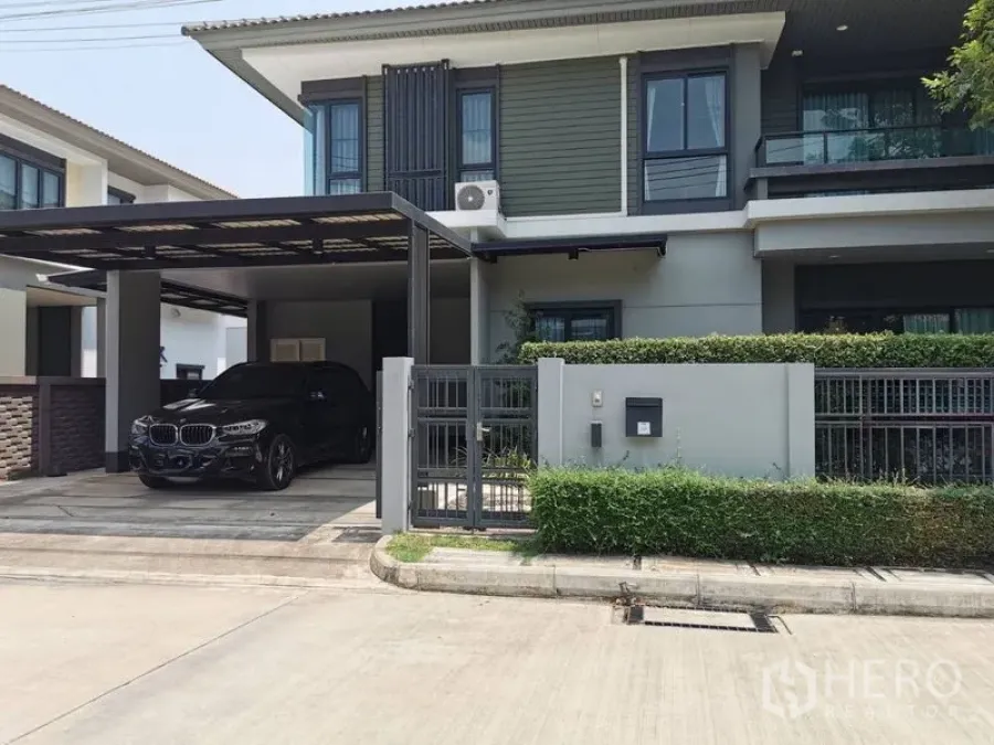 Detached House for rent or sale in Lam Luk Ka, Pathum Thani - Modern two-storey detached house with gated front yard and covered two-car carport