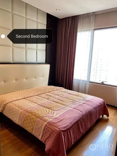 Condominium for rent - Second bedroom with padded headboard, wood flooring and city-view window
