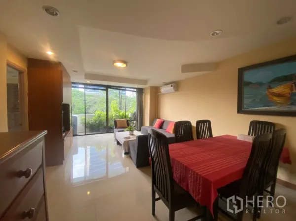 Condominium for rent in Phaya Thai, Bangkok - Open-plan living area with floor-to-ceiling glass doors and balcony plants.