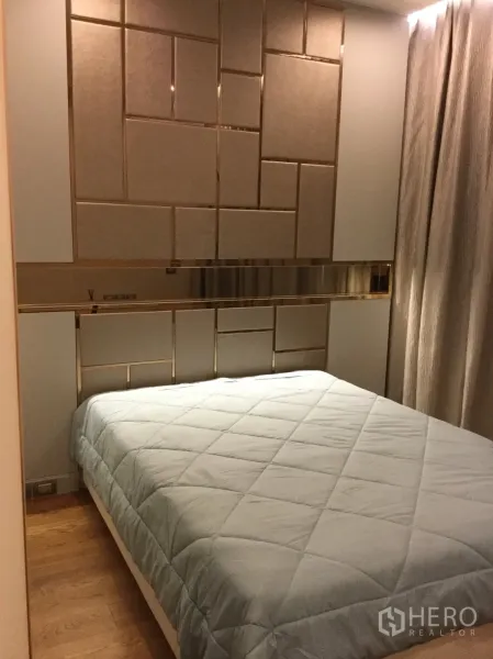 Condominium for rent in Sathon, Bangkok - Second bedroom featuring a geometric padded headboard, soft ambient lighting and blackout curtains.