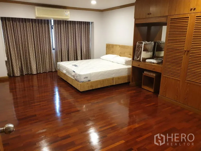 公寓 出租在Watthana, Bangkok - 第二卧室，带床、木质内置衣柜、梳妆台与长窗帘。
