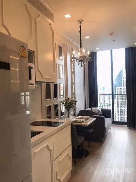 Condominium for rent in Watthana, Bangkok - Kitchenette and dining leading to sofa and balcony with city view