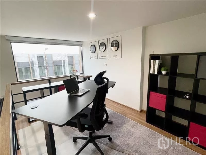 Townhouse for rent in Samut Prakan - Bright mezzanine study with wide window and cube shelving.
