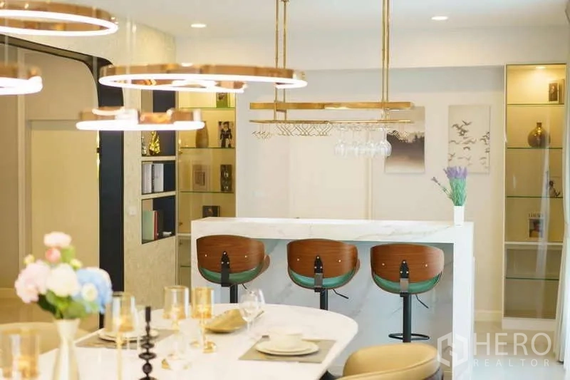 Detached House for rent or sale in Bang Phli, Samut Prakan - Breakfast bar with three stools, hanging glass rack and marble counter beside the dining area.