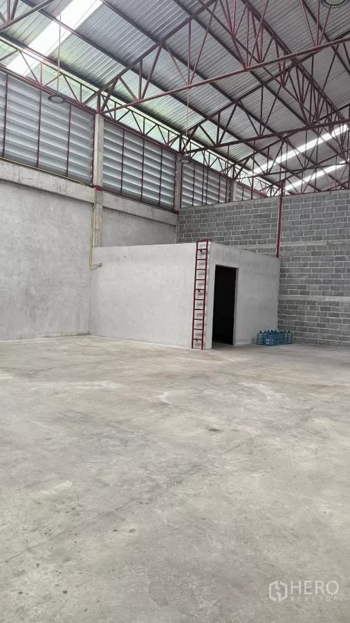 货栈 出租在Min Buri, Bangkok - 仓库角落设有内建办公室与梯子，旁为大面积混凝土地面。