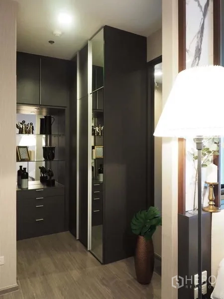 Condominium for rent in Khlong San, Bangkok - Built-in wardrobe corridor with tall cabinets, mirror, and accent lighting for ample storage.
