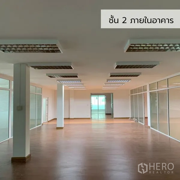 Office Space for rent in Bueng Kum, Bangkok - Open-plan office floor with glass-partitioned rooms and bright fluorescent lighting.