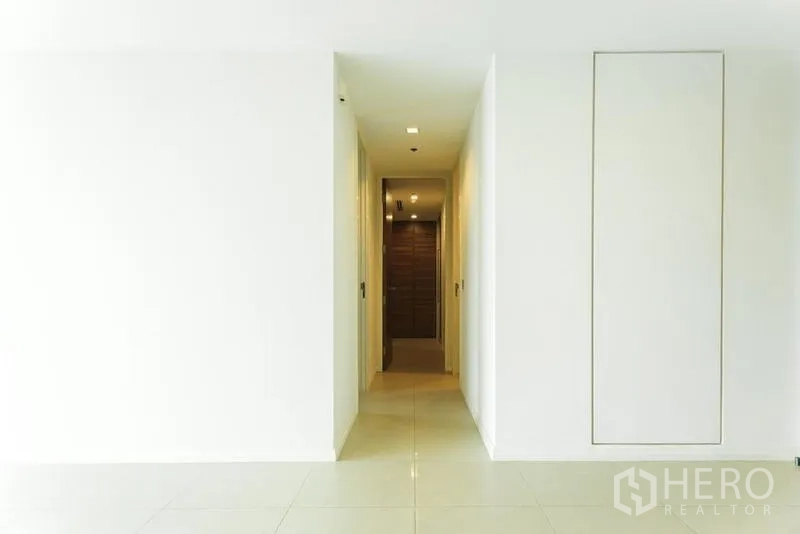 公寓 出售在Khlong San, Bangkok - 整洁走廊，嵌灯与收纳柜通向木门。
