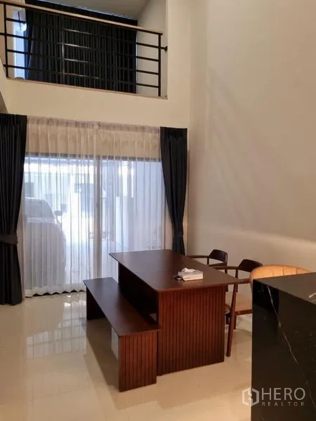 Townhouse for rent - Mezzanine hallway with metal railing leading to lounge and stairs.
