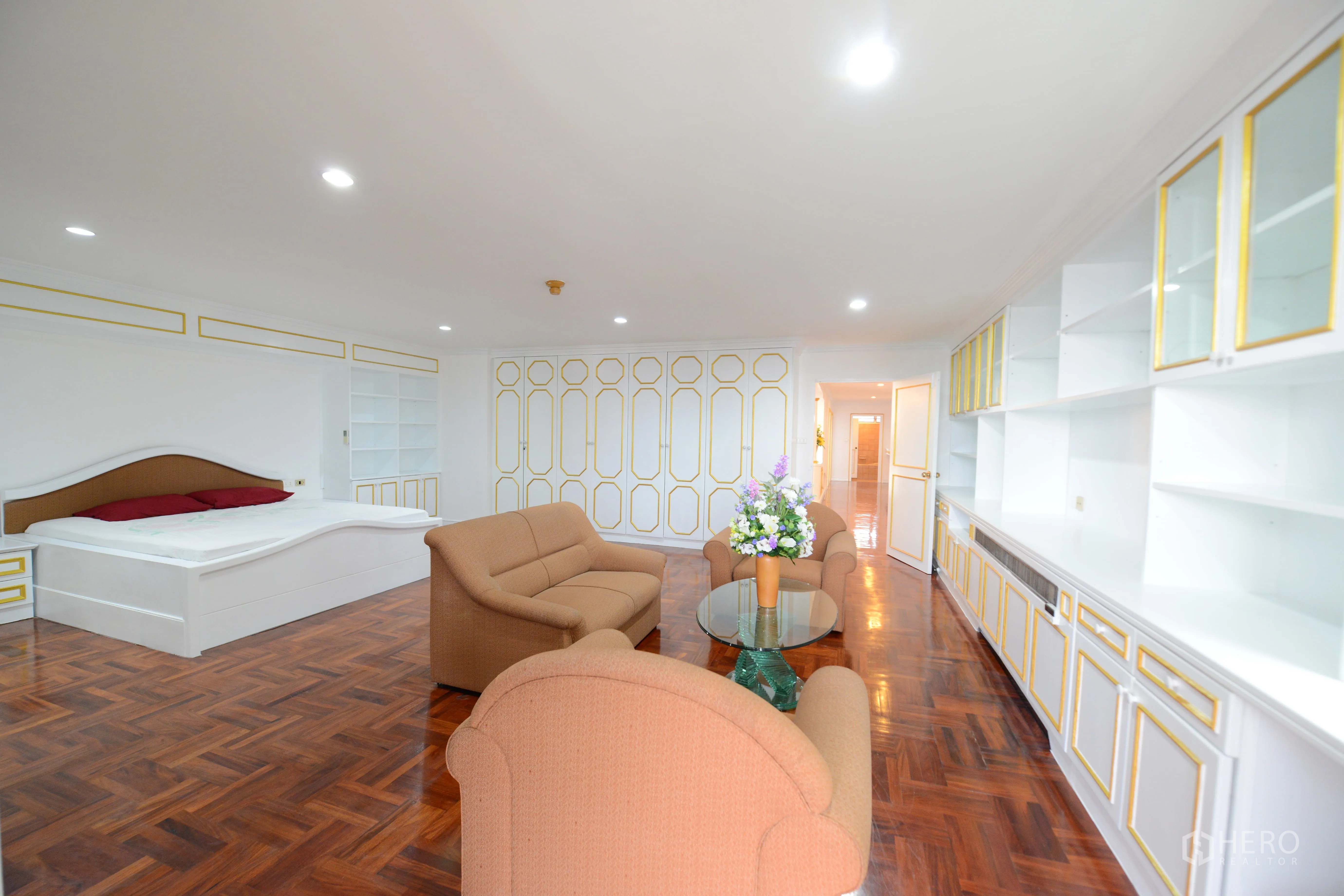 Condominium for rent or sale in Watthana, Bangkok - Alternate view of master bedroom showing custom bed, seating set and wall of storage