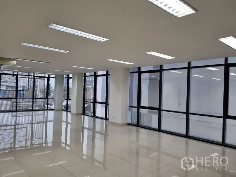 Office Space for rent in Bang Kho Laem, Bangkok - Bright open-plan office with glossy tile floors, black-framed floor-to-ceiling windows and fluorescent lighting in Bang Kho Laem.