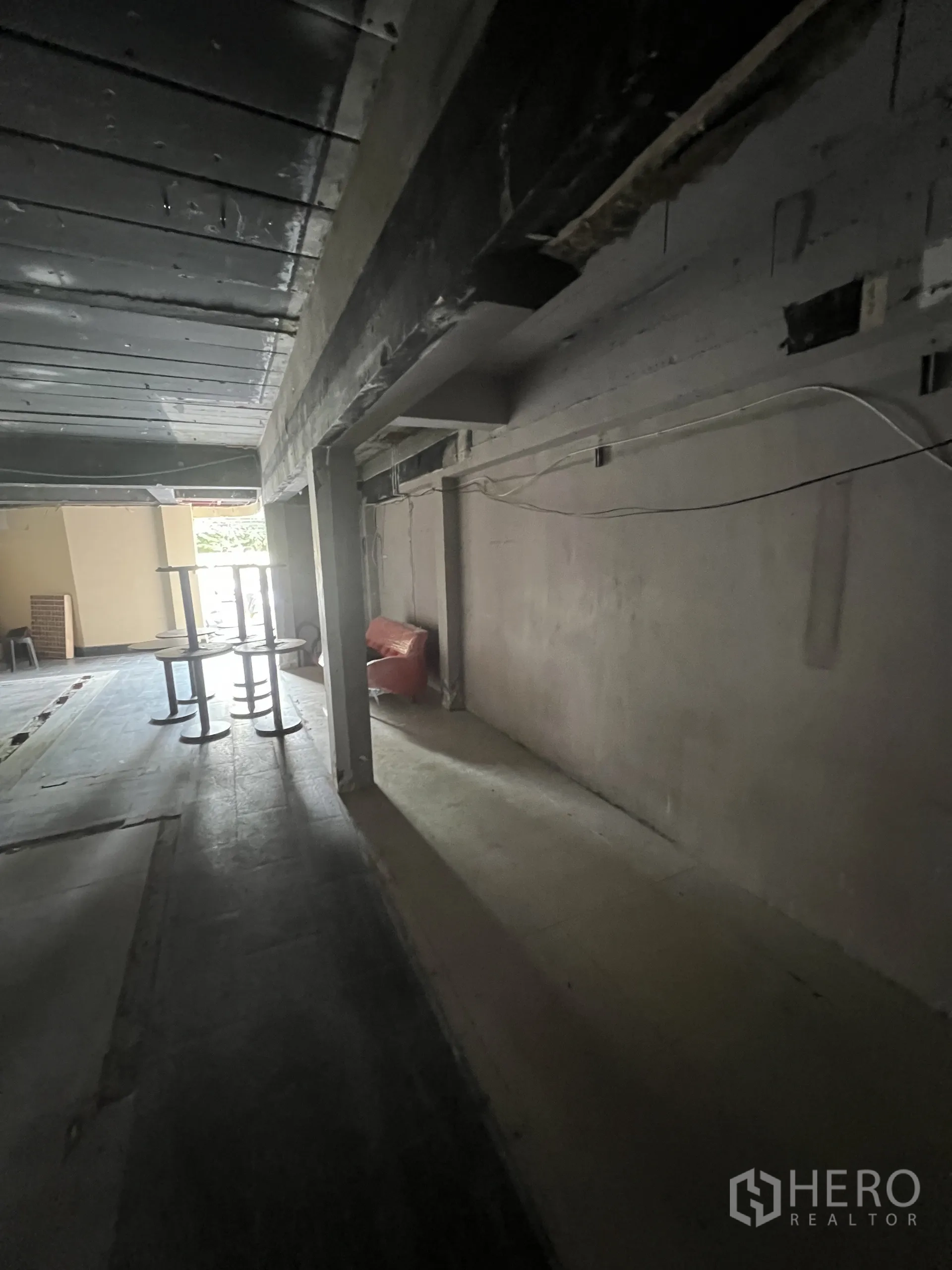 Retail Space for rent in Watthana, Bangkok - Side aisle of the shop showing structural beams, wiring and view toward the front opening.