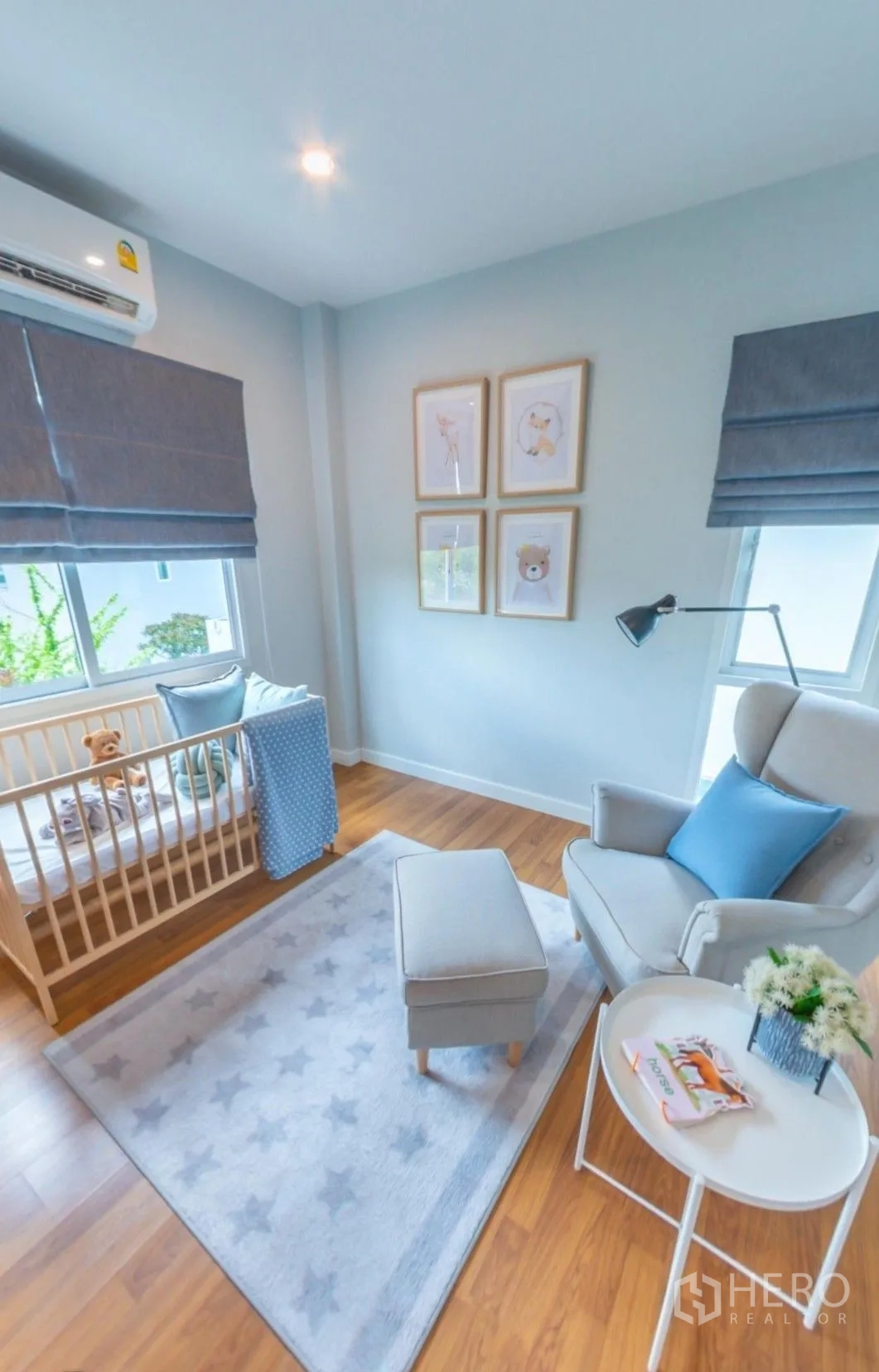 Detached House for rent in Lam Luk Ka, Pathum Thani - Bright nursery with crib, armchair, framed art, and windows with Roman shades.